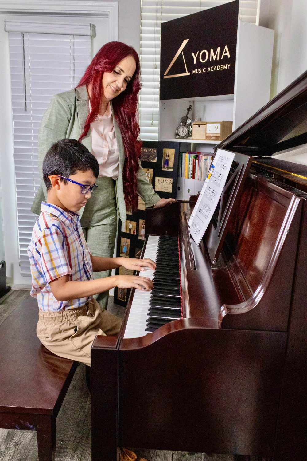 Child learning piano with Yarima Orellana