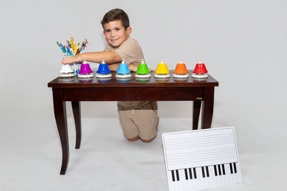 Young child exploring music with a sound instrument